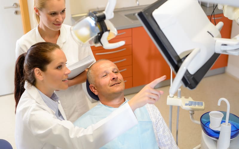 patient looking at root canal treatment x-ray in livonia